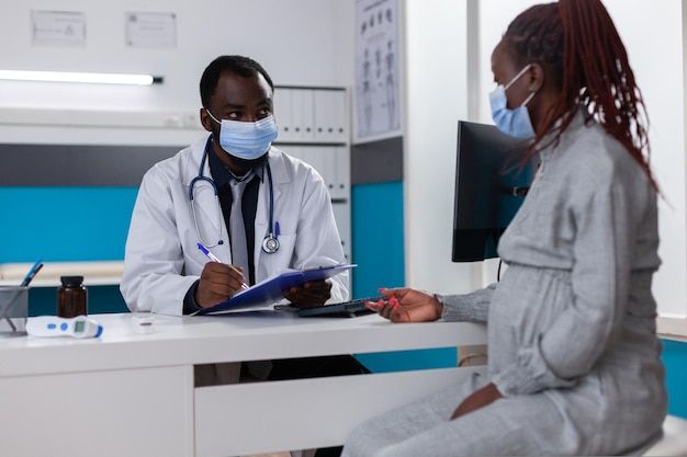 Young African woman scanning medication package with her phone